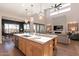 Island kitchen with white cabinets and a marble countertop at 23071 N 98Th Dr, Peoria, AZ 85383