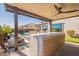 Outdoor kitchen with marble countertop and built in appliances at 23071 N 98Th Dr, Peoria, AZ 85383