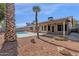 Relaxing backyard oasis with a refreshing pool, covered patio, and desert landscaping at 23827 N 44Th Ln, Glendale, AZ 85310