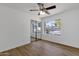 Bedroom with large window, mirrored closet, and wood-look floors at 23827 N 44Th Ln, Glendale, AZ 85310