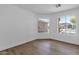 Bedroom with two large windows and wood-look floors at 23827 N 44Th Ln, Glendale, AZ 85310