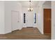 Bright foyer with wood-look floors and chandelier at 23827 N 44Th Ln, Glendale, AZ 85310