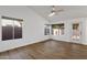 Bright living room with wood-look floors and sliding door to patio at 23827 N 44Th Ln, Glendale, AZ 85310