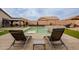 Relax by the pool and spa, surrounded by artificial turf and featuring shaded seating areas for ultimate outdoor enjoyment at 23933 N 167Th Ln, Surprise, AZ 85387