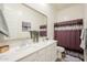 Bright bathroom featuring double sinks, quartz countertops, and a large mirror at 23933 N 167Th Ln, Surprise, AZ 85387