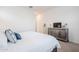 Bright bedroom featuring a plush bed, stylish dresser with TV, and neutral decor at 23933 N 167Th Ln, Surprise, AZ 85387