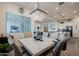 Dining area with a large marble table and modern light fixture, with a view of the kitchen and living area at 23933 N 167Th Ln, Surprise, AZ 85387