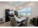 The dining room features a modern chandelier and lots of bright, natural light at 23933 N 167Th Ln, Surprise, AZ 85387