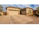 Charming home featuring a three-car garage and manicured landscaping on a sunny day at 23933 N 167Th Ln, Surprise, AZ 85387