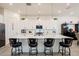 Stylish kitchen with a large island, modern pendant lighting, and white cabinetry with dark hardware at 23933 N 167Th Ln, Surprise, AZ 85387