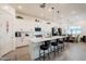 Modern kitchen with white cabinetry, quartz countertops, and a large island with seating at 23933 N 167Th Ln, Surprise, AZ 85387