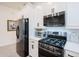 Modern kitchen featuring black appliances, white cabinets, and plenty of countertop space at 23933 N 167Th Ln, Surprise, AZ 85387