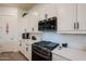 Close-up of the kitchen featuring stainless steel appliances and bright white cabinetry at 23933 N 167Th Ln, Surprise, AZ 85387