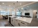 Bright open kitchen featuring quartz counters, stainless appliances and easy access to the living room at 23933 N 167Th Ln, Surprise, AZ 85387