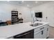 Modern kitchen island featuring sleek stainless-steel sink and black hardware at 23933 N 167Th Ln, Surprise, AZ 85387