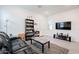 Modern living room featuring gray tile floors, a comfortable leather couch, and plenty of entertainment space at 23933 N 167Th Ln, Surprise, AZ 85387