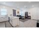 Bright open-concept living space with a kitchen island, sleek black furniture, and modern decor creates an inviting atmosphere at 23933 N 167Th Ln, Surprise, AZ 85387