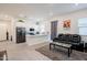 Bright open-concept living space with a kitchen island, sleek black furniture, and modern decor creates an inviting atmosphere at 23933 N 167Th Ln, Surprise, AZ 85387