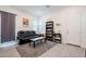 Cozy living room with gray rug, comfortable black couch, and bookcase for plenty of storage at 23933 N 167Th Ln, Surprise, AZ 85387