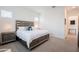 Spacious main bedroom featuring a large bed, carpet flooring, and ensuite bath at 23933 N 167Th Ln, Surprise, AZ 85387