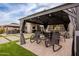 Inviting patio with comfortable seating and views of the beautifully landscaped backyard at 23933 N 167Th Ln, Surprise, AZ 85387