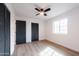 Simple bedroom with hardwood floors, ceiling fan, and ample closet space at 2446 E Marilyn Rd, Phoenix, AZ 85032