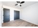 Well-lit bedroom with dark gray doors and hardwood floors at 2446 E Marilyn Rd, Phoenix, AZ 85032