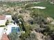 Beautiful aerial view of the pool, patio, golf course and desert landscaping surrounding the property at 27545 N 97Th Pl, Scottsdale, AZ 85262