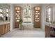 Spacious, bright bathroom features a stand alone tub centered between tall cabinets and pendant lighting at 27545 N 97Th Pl, Scottsdale, AZ 85262