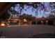 Elegant home exterior with well-lit driveway, a two-car garage and lush desert landscaping at 27545 N 97Th Pl, Scottsdale, AZ 85262