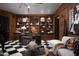 Elegant living room boasting wood paneling, custom built-ins, and striking checkerboard flooring at 27545 N 97Th Pl, Scottsdale, AZ 85262