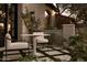 Charming outdoor seating area with a marble table and lush greenery at 27545 N 97Th Pl, Scottsdale, AZ 85262