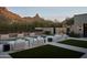 Beautiful pool area with lounge chairs, mountain views, and an outdoor kitchen at 27545 N 97Th Pl, Scottsdale, AZ 85262