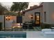 Outdoor living with a pool, barbecue area, and exterior lighting for relaxing evenings at 27545 N 97Th Pl, Scottsdale, AZ 85262