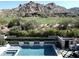 Stunning swimming pool with integrated spa, set against a mountain view and golf course backdrop at 27545 N 97Th Pl, Scottsdale, AZ 85262