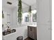 Bright secondary bathroom featuring modern fixtures, vanity, and large decorative mirror with leafy vines at 2912 E Clarendon Ave, Phoenix, AZ 85016