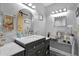 Bathroom featuring a vanity with a marble countertop, mirrored makeup station, and modern fixtures at 2912 E Clarendon Ave, Phoenix, AZ 85016