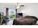 Bright bedroom with natural light, a ceiling fan, a patterned accent window, and modern furnishings at 2912 E Clarendon Ave, Phoenix, AZ 85016