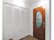 Entryway featuring a decorative wood door with an oval glass insert and a large white closet with folding doors at 2912 E Clarendon Ave, Phoenix, AZ 85016