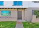 Welcoming townhome entrance with landscaped lawn and unique architectural details at 2912 E Clarendon Ave, Phoenix, AZ 85016