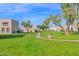 Community grounds featuring a walking path and mature trees at 2912 E Clarendon Ave, Phoenix, AZ 85016