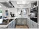 Updated kitchen featuring tile countertops, white cabinetry and modern stainless steel appliances at 2912 E Clarendon Ave, Phoenix, AZ 85016