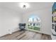 Bright room featuring wood-look floors, a curved window with neighborhood views, and modern furnishings and decor at 2912 E Clarendon Ave, Phoenix, AZ 85016