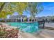 Beautiful community pool with tiled accents, shaded seating, and lush landscaping at 2912 E Clarendon Ave, Phoenix, AZ 85016