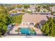 Aerial view of a backyard oasis with a swimming pool, covered patio, and lush landscaping at 2939 E Huber St, Mesa, AZ 85213