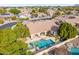 Aerial view of a home's backyard featuring a sparkling pool, spa, and covered outdoor space at 2939 E Huber St, Mesa, AZ 85213