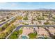 Expansive aerial view of a neighborhood featuring diverse homes, mature trees, and a nearby canal at 2939 E Huber St, Mesa, AZ 85213