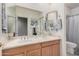 Bright bathroom featuring a double sink vanity and decorative mirrors at 2939 E Huber St, Mesa, AZ 85213