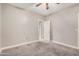 Bedroom with neutral carpeting, ceiling fan, and open doorway at 2939 E Huber St, Mesa, AZ 85213