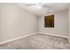 Bedroom with neutral carpeting, ceiling fan and a window with wood blinds at 2939 E Huber St, Mesa, AZ 85213